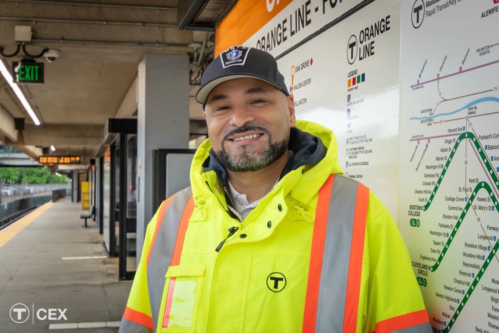 Inspector for the MBTA standing in front of a train stop